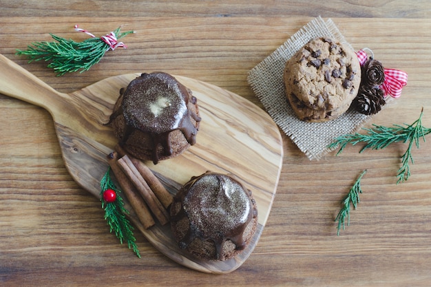 Chocolate muffin on wooden background.