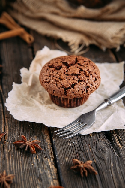 Chocolate muffin on a wooden table close-up