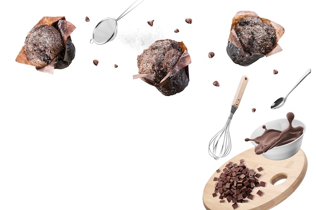 Chocolate muffins or cupcakes with set of kitchen utensils on white