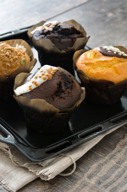 Chocolate muffins on a rustic wood table