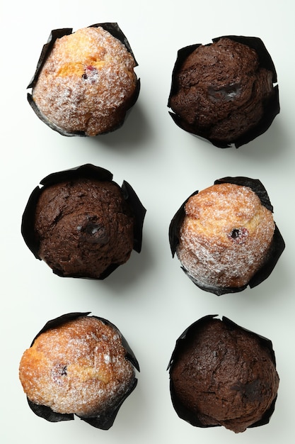 Chocolate muffins on white background, top view.