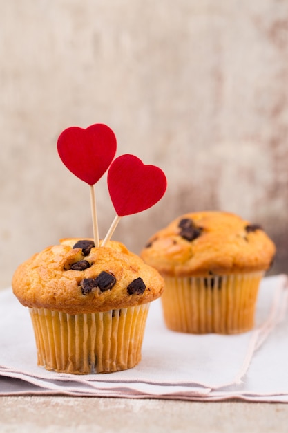 Photo chocolate muffins with heart vintage surface, selective focus.