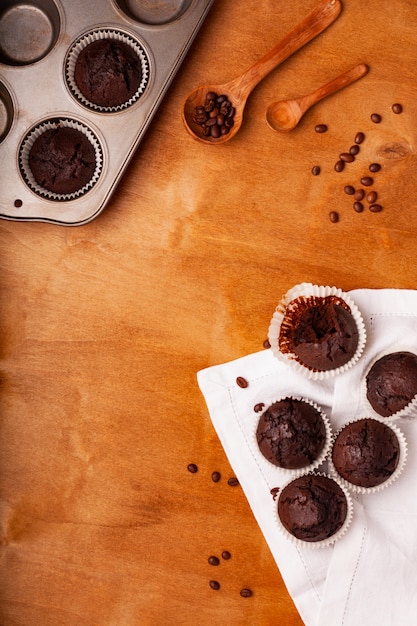 Chocolate muffins on a wooden background