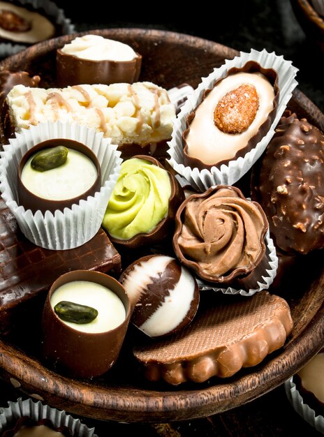 Chocolate nut candies in a wooden bowl.