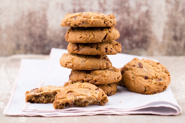 Chocolate oatmeal chip cookies on the rustic wooden table.