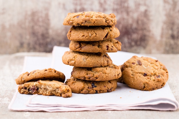 Chocolate oatmeal chip cookies on rustic wooden table.