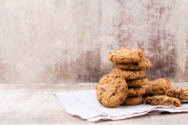 Chocolate oatmeal chip cookies on rustic wooden table.