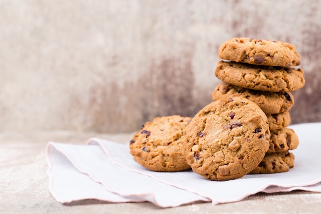 Chocolate oatmeal cookies on the wooden background