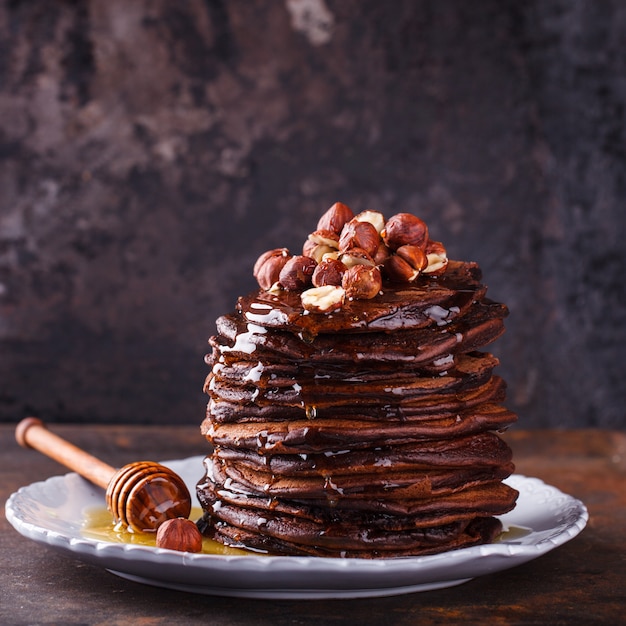 Chocolate pancake with honey and hazelnuts