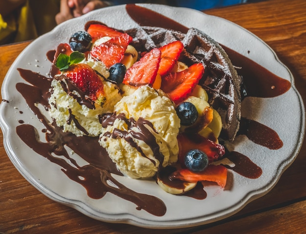 Chocolate Pancakes with banana, strawberry, blueberry, ice cream, brownies and chocolate.