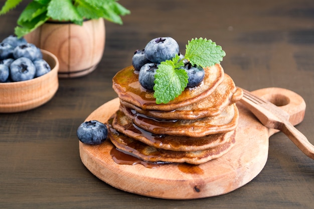Chocolate pancakes with blueberries on a dark background.