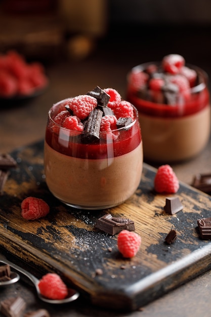 Chocolate panna cotta with raspberry jelly, raspberries and chocolate pieces