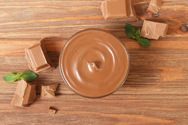 Chocolate paste in a glass jar on a colored background