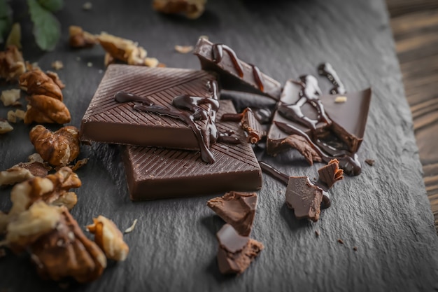 Chocolate pieces with walnuts on slate plate