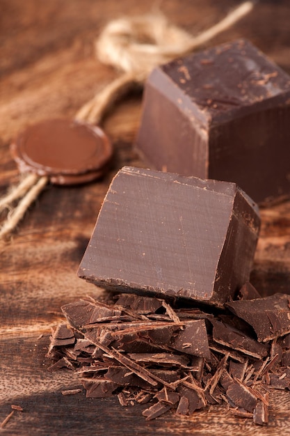 Chocolate pieces on wooden background