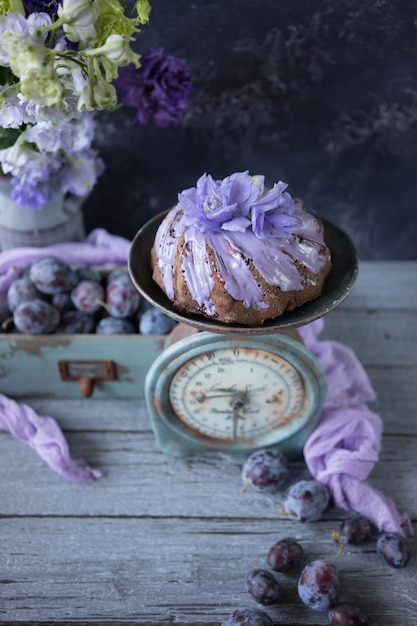 Chocolate plum cake with lilac flowers