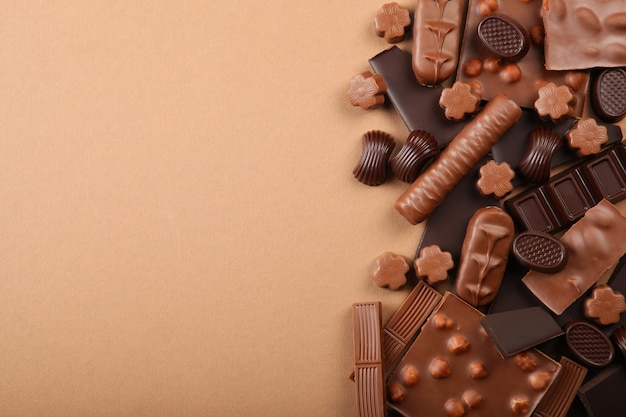 Photo chocolate products of different types on a colored background closeup with a place for text