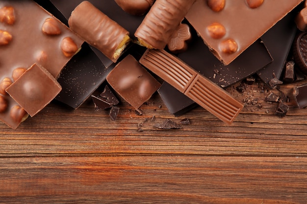 Chocolate products of different types on a colored background closeup with a place for text