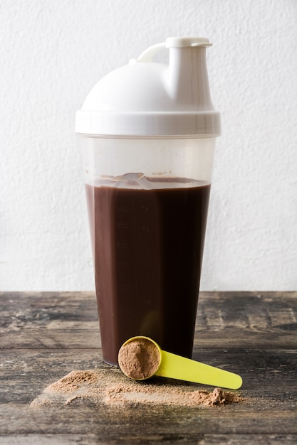 Chocolate protein shake on wooden table