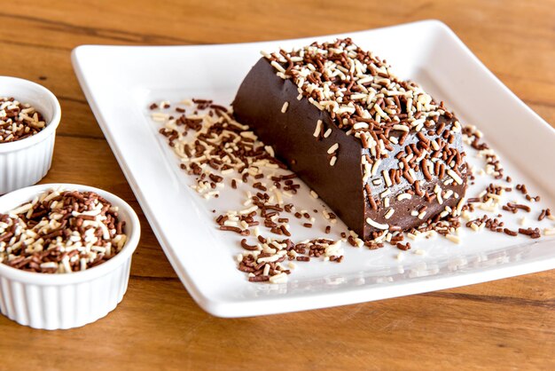 Chocolate pudding with sprinkles, delicious chocolate dessert on wooden table