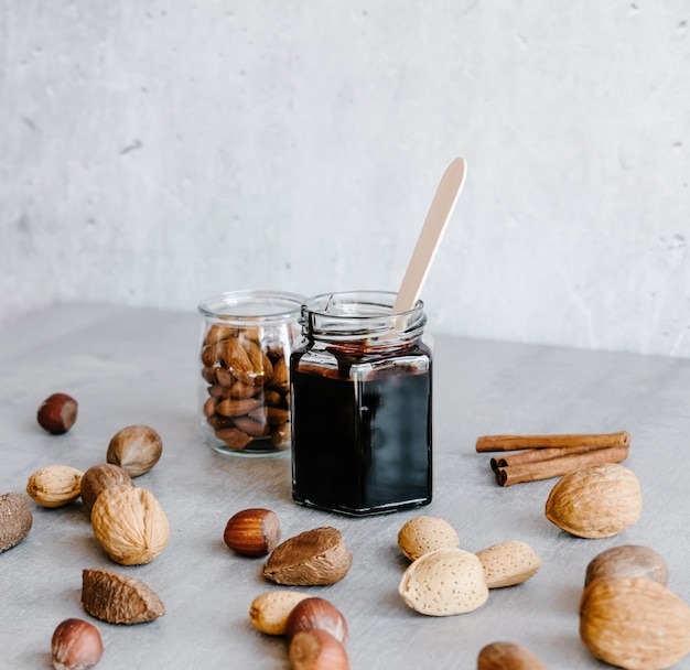 Chocolate sauce and nuts in jars