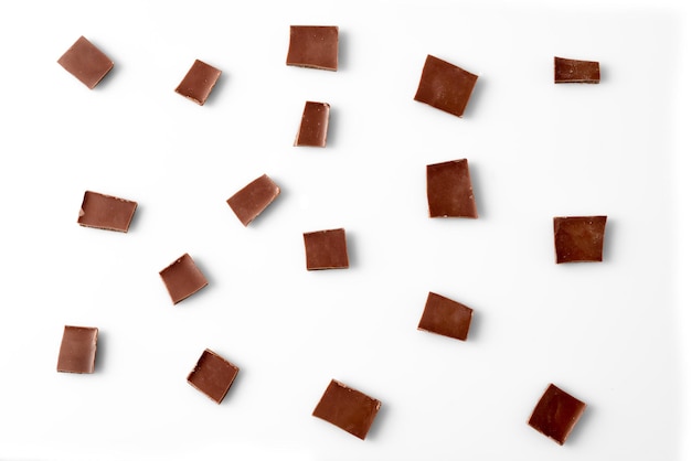 Photo chocolate slices on white background top view