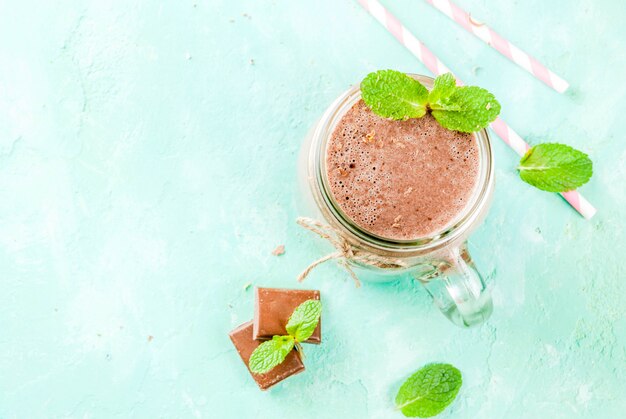 Chocolate smoothie with mint and straw in mason jar