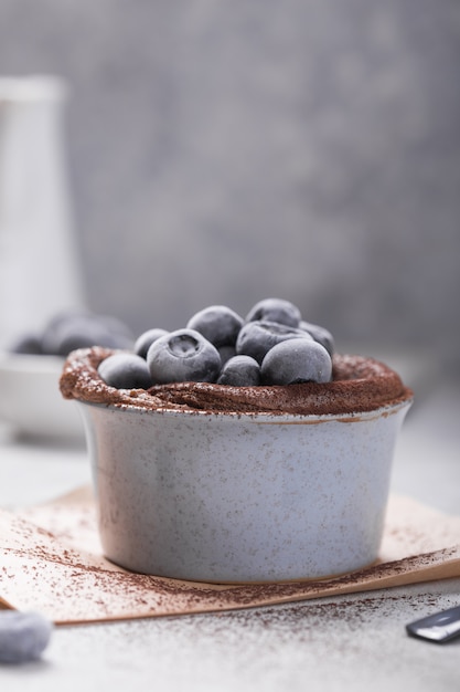 Chocolate Souffle with frozen blueberry. French traditional dessert.