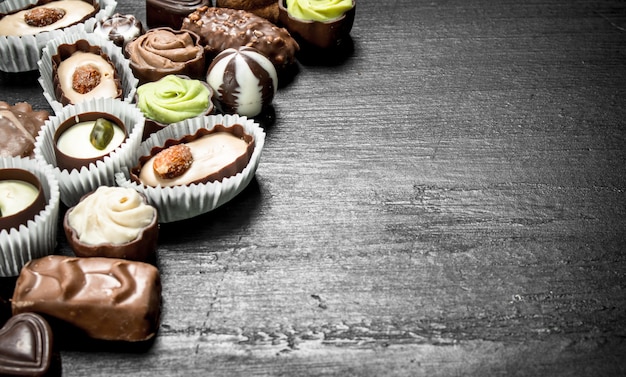 Chocolate sweet candies. On the black chalkboard.