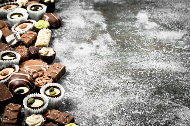 Chocolate sweet candies. On the rustic background.