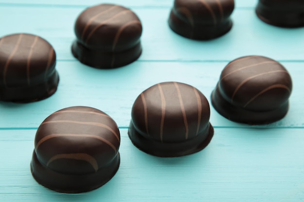 Chocolate sweets on a blue wooden background. Biscuit