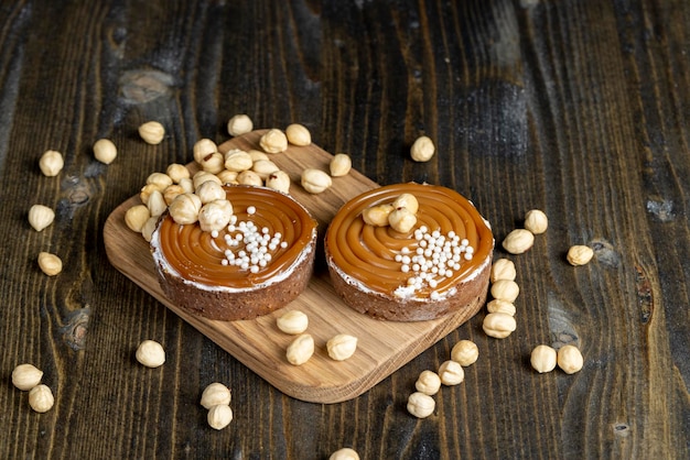 Chocolate tartlet with cream filling and salted caramel with nuts