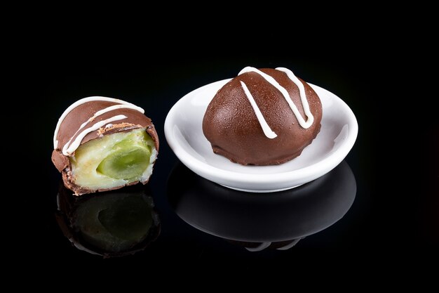 Chocolate truffle with green grape filling