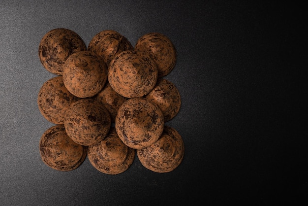 Chocolate truffles on a black background Chocolate candies