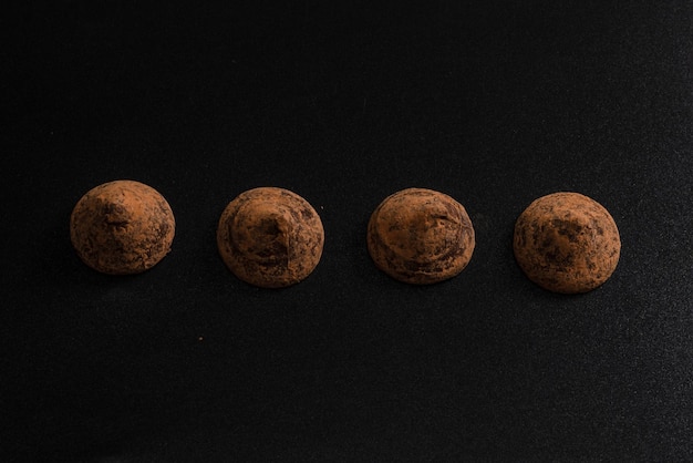 Chocolate truffles on a black background