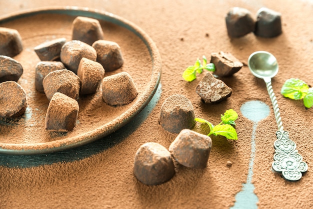 Chocolate truffles on cocoa powder table