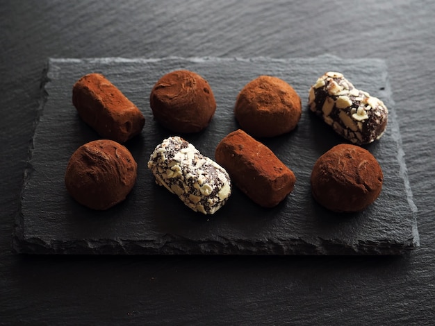 Chocolate truffles on dark table