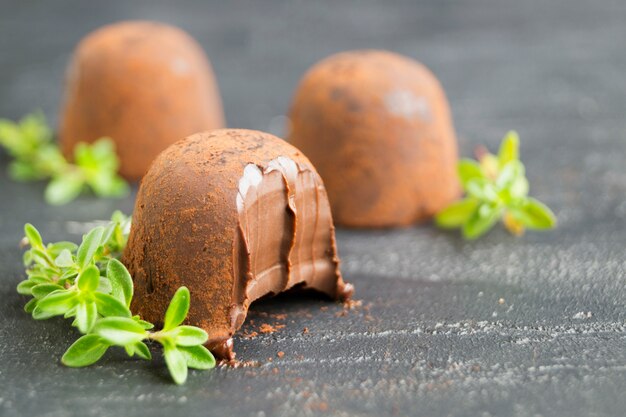 Chocolate truffles on a grey background.