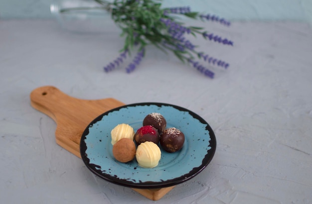 Chocolate truffles, homemade chocolate. Delicious chocolate candies. Group of sweet chocolate truffles on gray background. Selective focus.