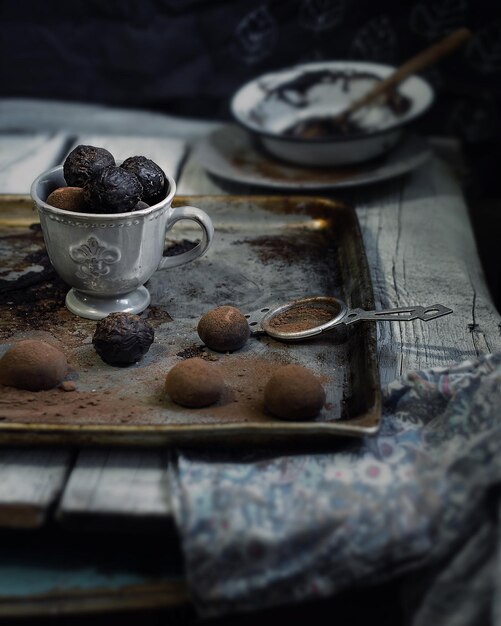 chocolate truffles with cocoa on vintage wooden background.