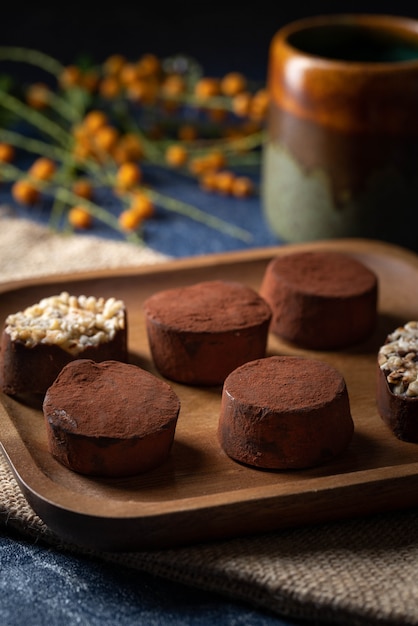 Chocolate truffles on a wooden plate