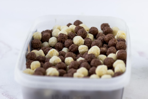 Chocolate and vanilla balls Quick breakfast of corn snacks closeup