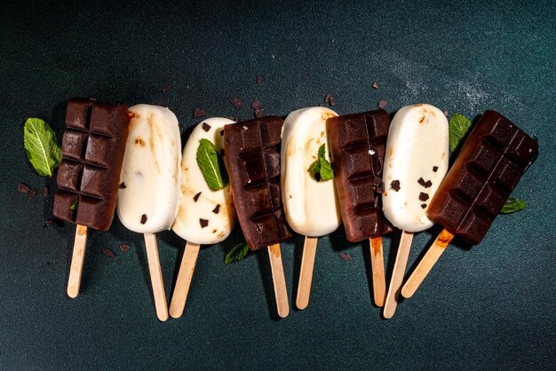 Chocolate and vanilla popsicles Classic dark brown cocoa and milk cream ice cream lolly pops Stack of various icecream lollies flatlay top view copy space