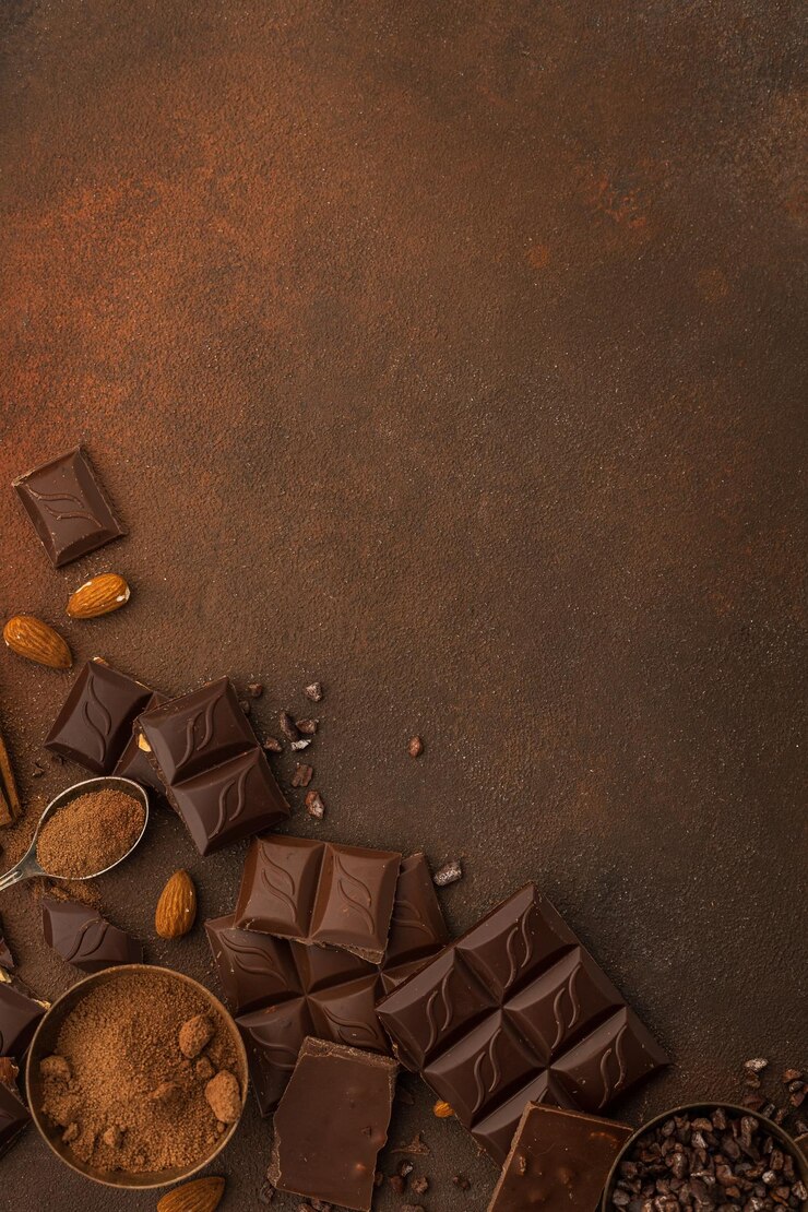 Chocolate variety on brown background copy space