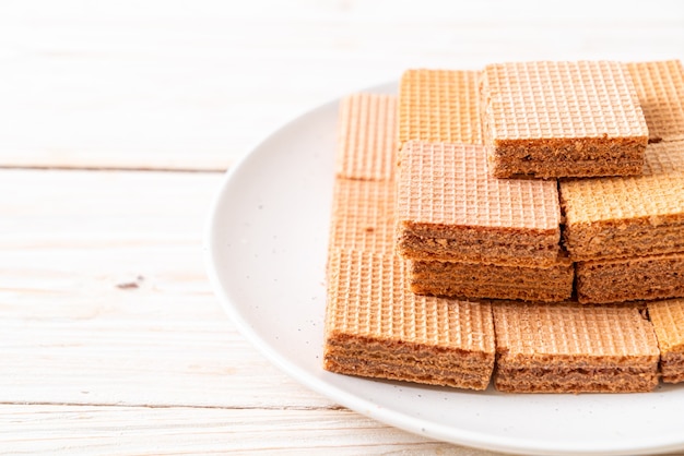 chocolate wafers with chocolate cream on wood surface