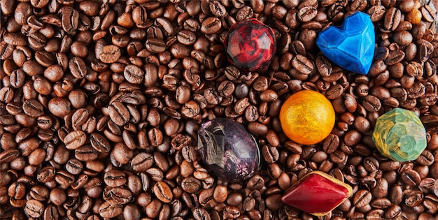 Chocolates in the form of precious stones on coffee beans