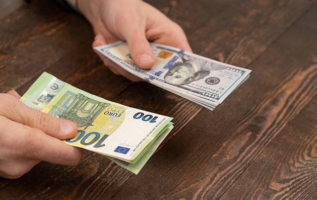 Photo choice dollars or euros exchange dollars to euro money in male hand
