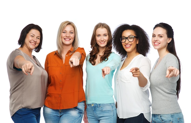 choice, friendship, fashion, diverse people concept - group of happy plus size women in casual clothes pointing finger on you