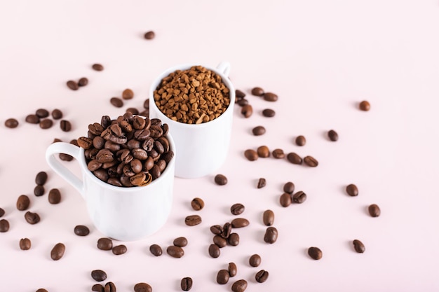 Choice between instant coffee and roasted coffee beans in cups on pink background