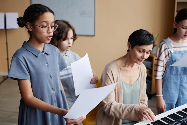 Choir of children singing songs in class